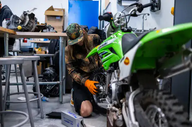 teen-boy-fixing-motorcycle